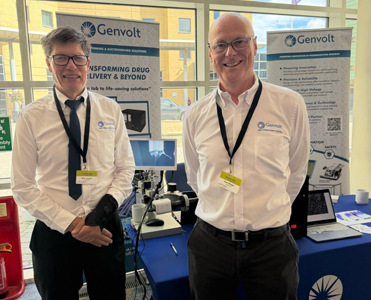 The Genvolt team attending PharmSci 2026 standing in front of the exhibition booth, smiling at the camera